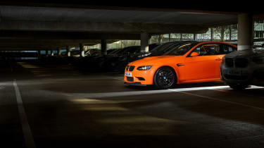 An orange BMW M in a car park