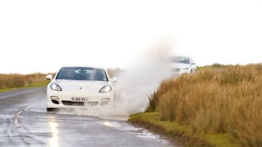 Porsche Panamera white, front driving water splash