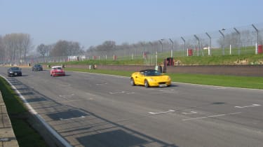 James Bowyer followed closely by father Peter in the MGB