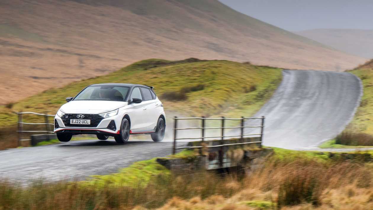 Hyundai i20 N front view close-up showing the N grille, LED headlights, and red front splitter accent