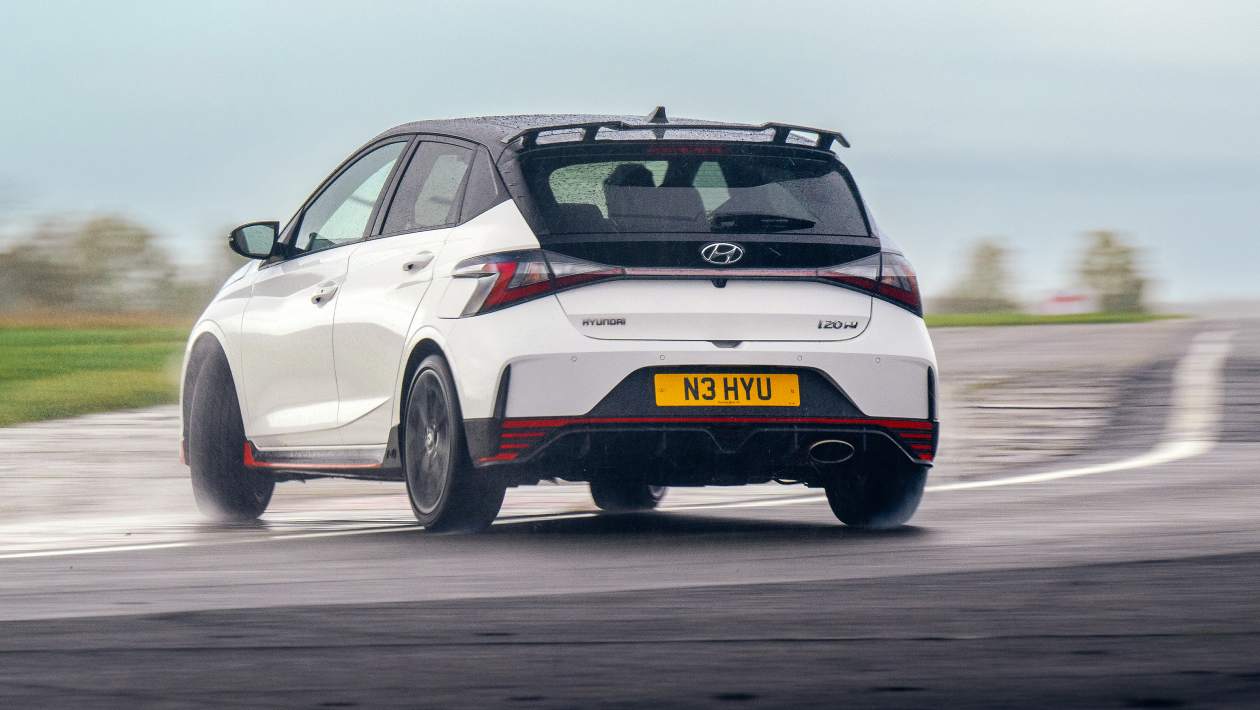 Hyundai i20 N rear three-quarter view showing the triangular fog lamp and N-specific rear styling