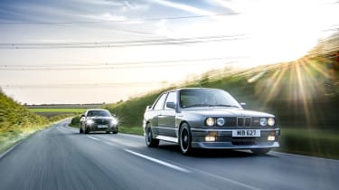 Two BMW M cars on the road