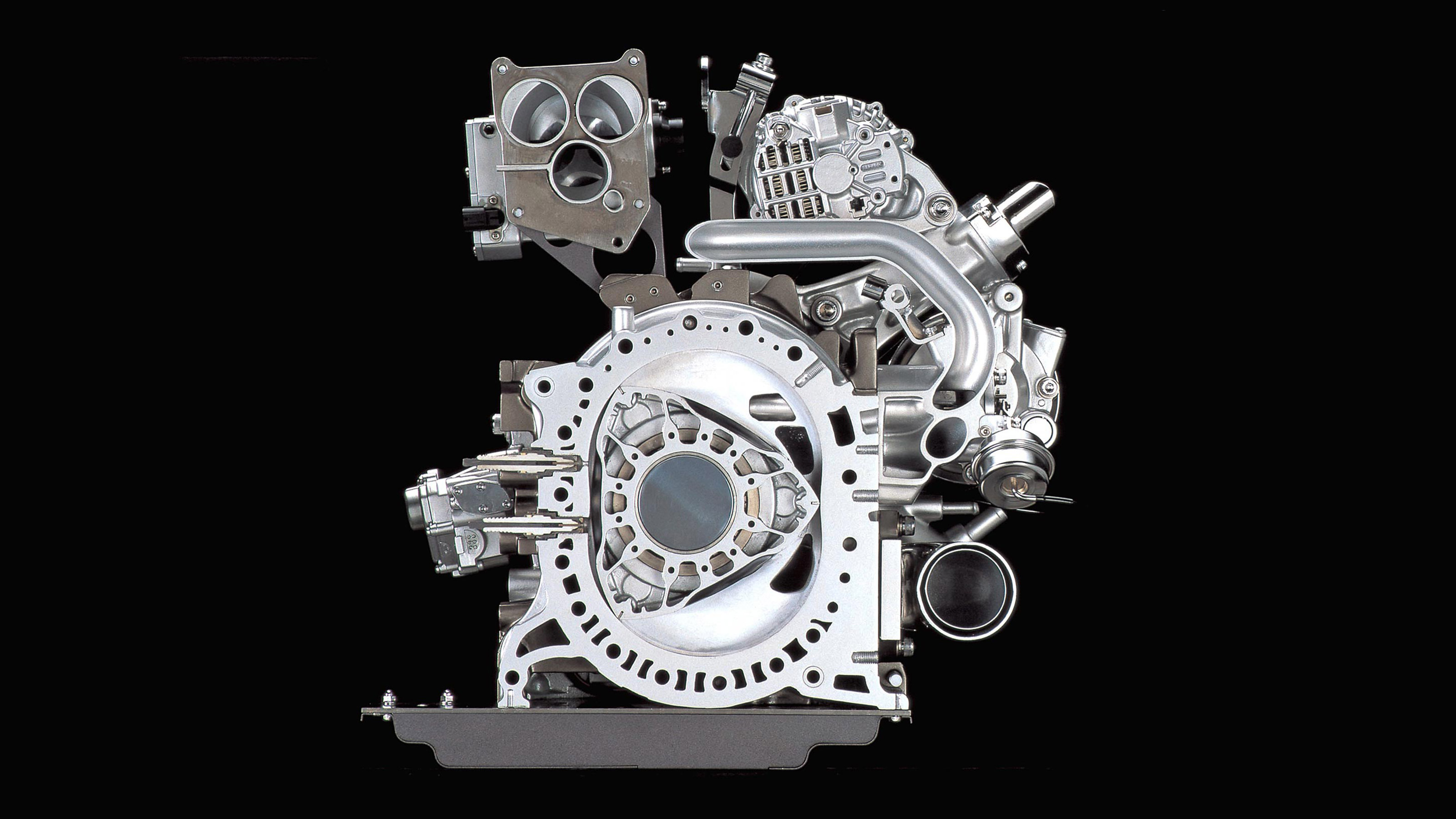 Поршневой двигатель автомобиля. Роторно-поршневой двигатель Ванкеля. Роторно поршневой двигатель ванкле. Mazda Wankel engine. Роторный двигатель Ванкеля.