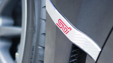 Subaru Impreza Cosworth badge by wheel